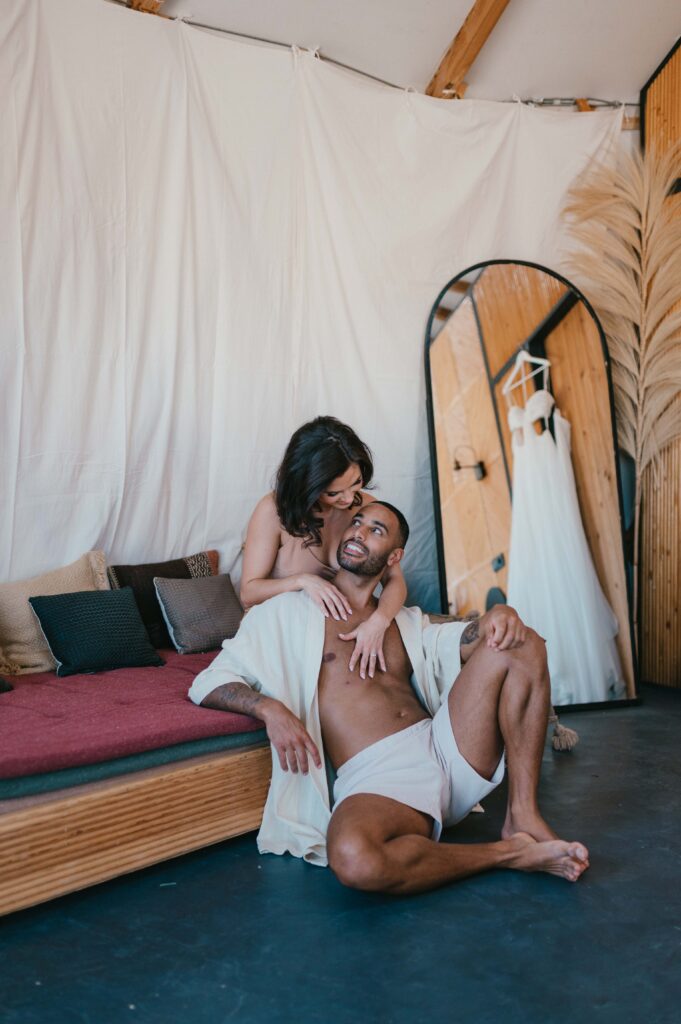 Megan and James getting ready in their luxurious glamping tent at Be Agafay, nestled in the Marrakech desert, captured by Marrakech wedding photographer Sarah Hurja.
