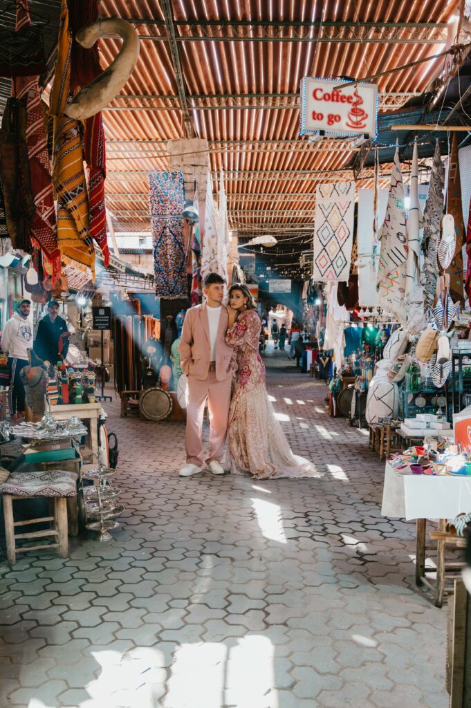 Paul and Lisa’s elopement wedding in Marrakech, with warm rays of sunshine streaming through the souk’s roof, casting a magical glow over the couple as they share a special moment.