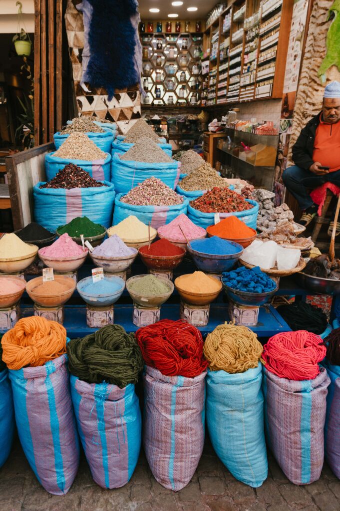 Bags of colourful wool and spices in Marrakech medina.